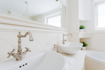 Chrome accents in creamy bathroom