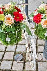 Fototapeta na wymiar White steel bike and flower pots 
