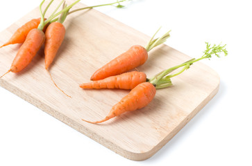 small carrots on wood plate