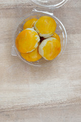 Chinese pastry or moon cake in plastic bowl on wooden table, chi