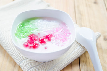 Tub Tim Krob ,Stuffed Water Chestnut in Syrup and Coconut Milk on wood table