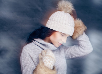 Portrait of brunette woman in warm winter hat.