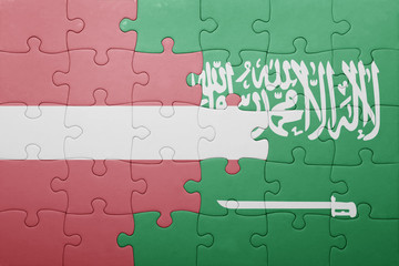 Fototapeta premium puzzle with the national flag of saudi arabia and latvia