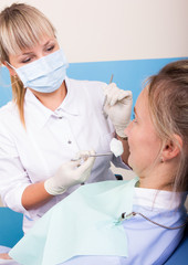 The reception was at the female dentist. Doctor examines the oral cavity on tooth decay.