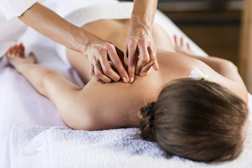 Woman enjoying massage. - obrazy, fototapety, plakaty