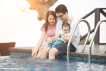 asian family having fun at the pool