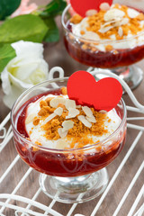 Dessert with jam and whipped cream for Valentine's Day, vertical