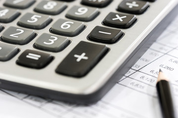 Calculator on the Financial table with pencil