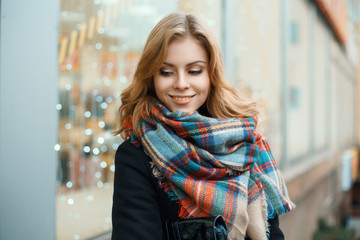 Beautiful happy woman with a vintage scarf on the background of blue lights
