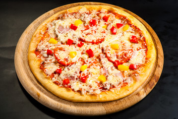 pizza on the board with ham
