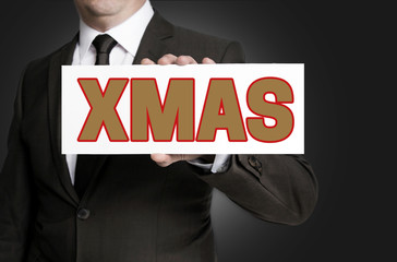xmas sign is held by businessman concept