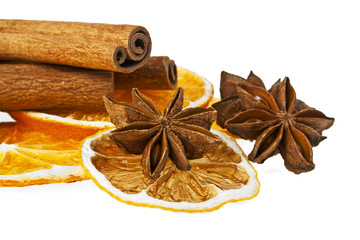 Christmas decoration - orange, cinnamon and anise on a white bac