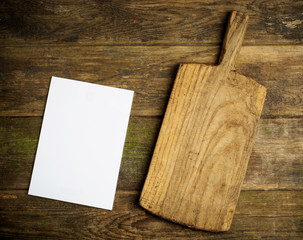 chopping board and empty page on rustic background 