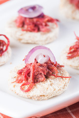 wheat bread topped with corned beef and sliced onions