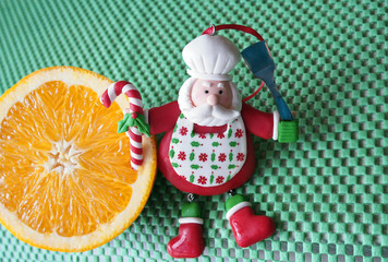 Christmas - green background,  orange and funny chef Santa Claus