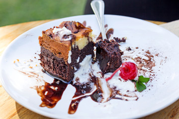 Chocolate Cake with cream cheese on a wood background