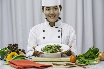 chef smiling and present a vegetarian dish