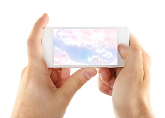 Hands holding mobile smart phone with sky in screen. Cloud computing concept