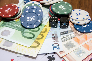 poker chips with playing card, euro note as background