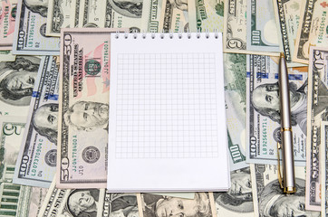 empty notebook above dollar