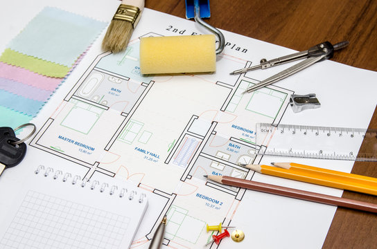 Construction planning of drawings apartment  with pencil, ruler, compass and keys, cloth and color swatch on the table