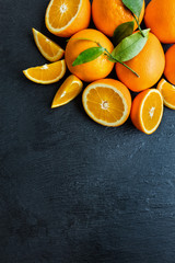 Fresh orange on black stone