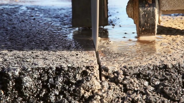 Worker cutting asphalt road, close up
