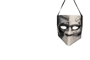 Venetian style masquerade mask in black and white hanging in front of a white background - 98236464