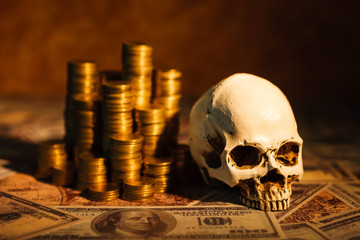 Capitalism concept : Skull on bank note, coin stack and vintage