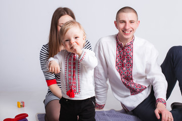 Pretty boy with parents in studio white