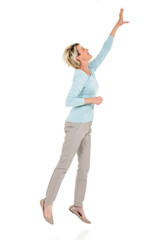 senior woman jumping up and reaching out