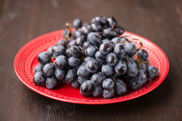 organic red grapes and fir branch with Christmas decorations