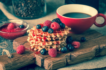 Belgian waffles with fresh berries and coffee