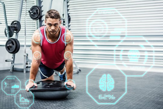 Composite image of portrait of muscular man using bosu ball