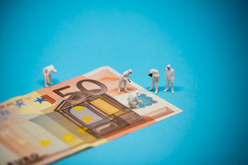 Specialists inspecting 50 euro banknote. Fraud concept