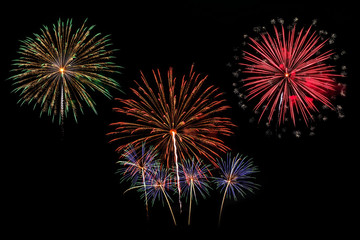 Colorful fireworks of various colors on black background