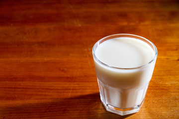Glass of milk on a wooden table