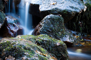 zen close up of river waterfall with rocks, long exposure effect of softness