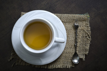 Cup of herbal tea on a wooden background