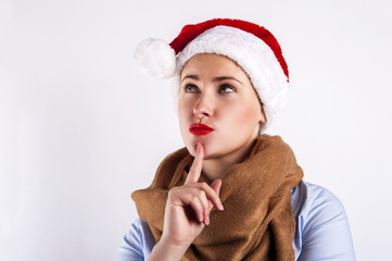 Woman in santa hat. Smiling over white background. Hand near fac