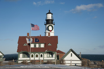 American Flag Waving at Portland Head Lighthouse During Holiday Season