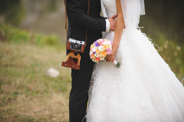 Newlyweds with Camera and Bouquet