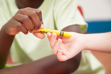 Kids sharing one pencil