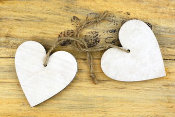 wooden background table, with wooden hearts shape frame decoration for invitation and announcement card

