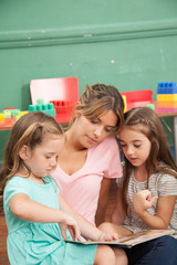 Teacher reading a book to her kindergarten class