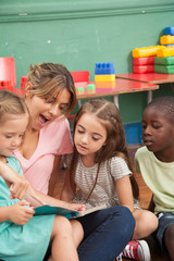 Teacher reading a book to her kindergarten class