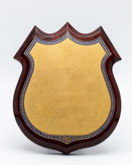 golden shield diploma in wooden frame isolated on white backgrou