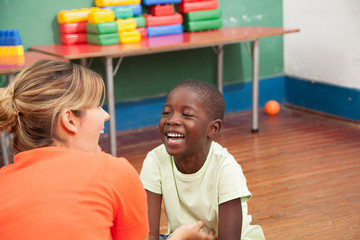 Teacher playing with a little student