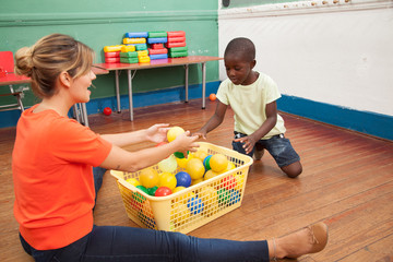 Teacher playing with a little student