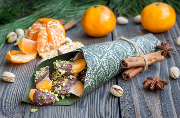 Mandarins covered with chocolate and pistachio